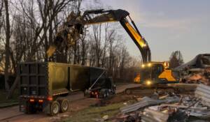 EnviroVantage excavator performing material processing at Dusk